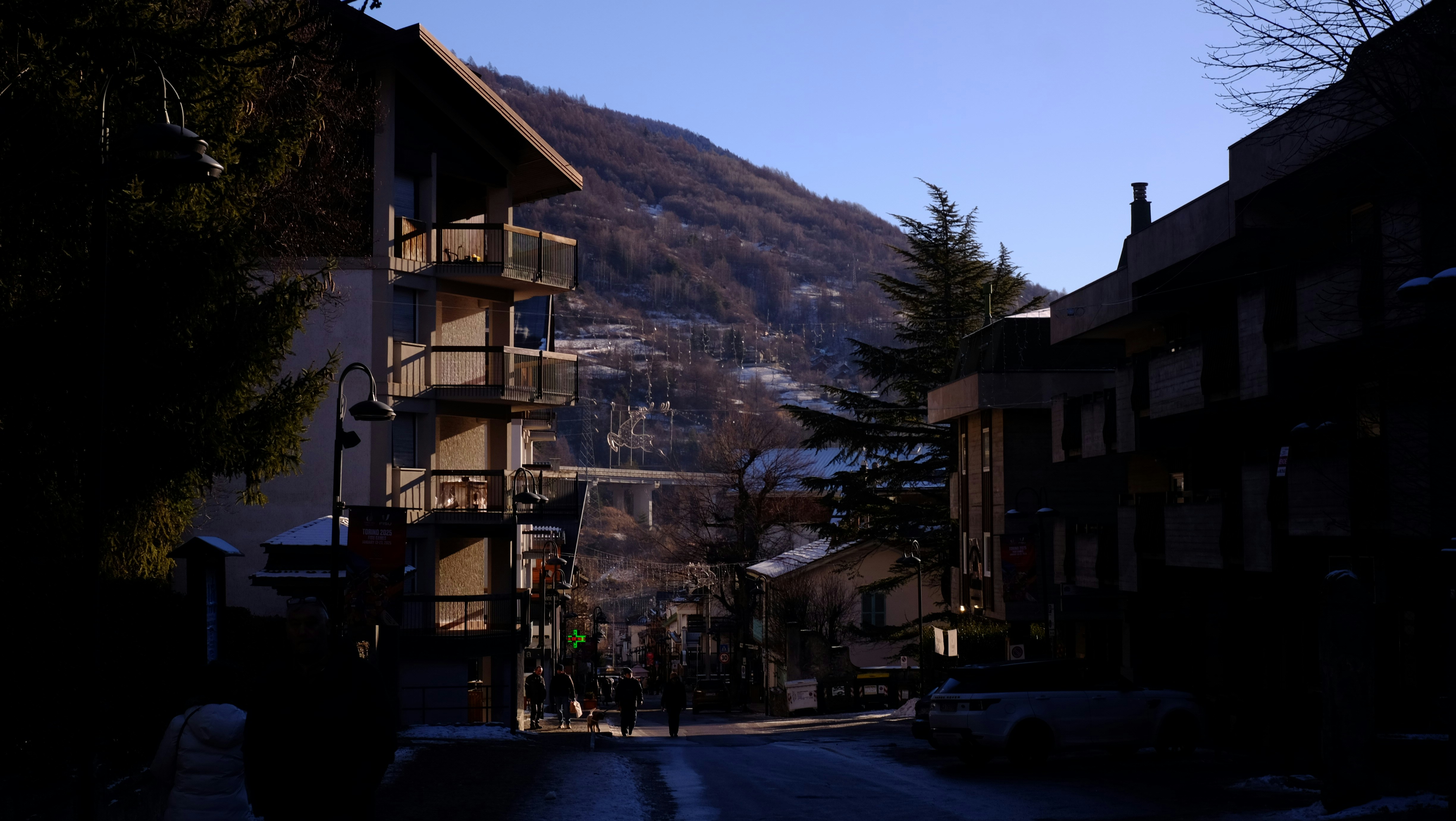 A city street with a mountain in the background
